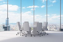 Meeting table and chairs in a bright room with a view